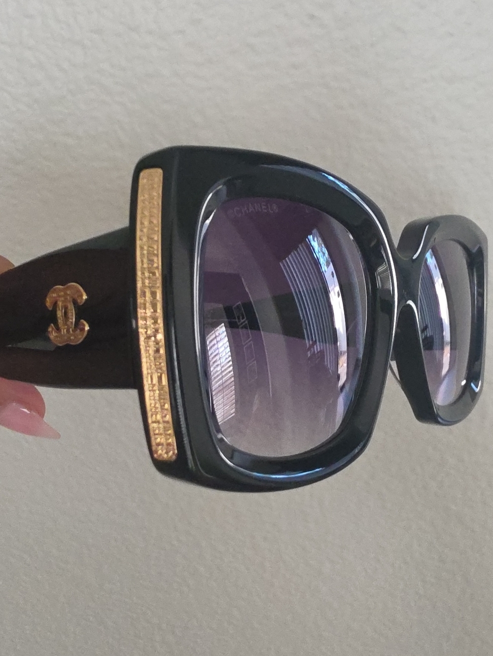 CHANEL Black Frame Sunglasses with Gold Accents and Gradient Purple Lenses